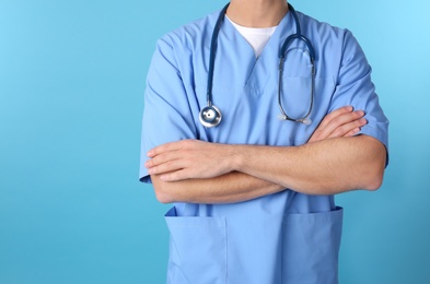 Photo of Young medical student in uniform on color background, closeup. Space for text