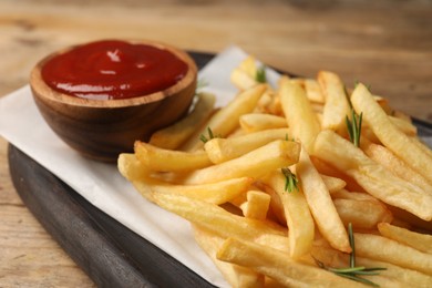 Delicious french fries served with ketchup on table, closeup