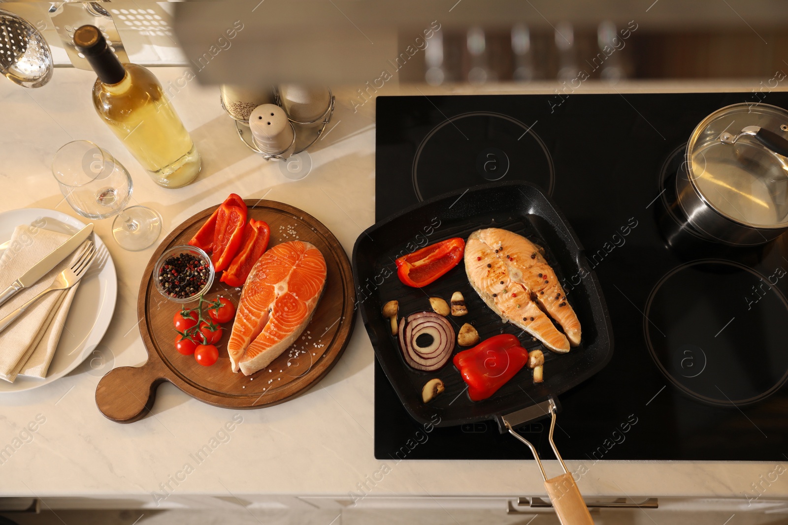 Photo of Composition with salmon steaks and vegetables in frying pan, above view