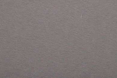 Photo of Texture of grey paper sheet as background, top view