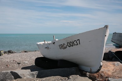 White boat near sea on sunny day