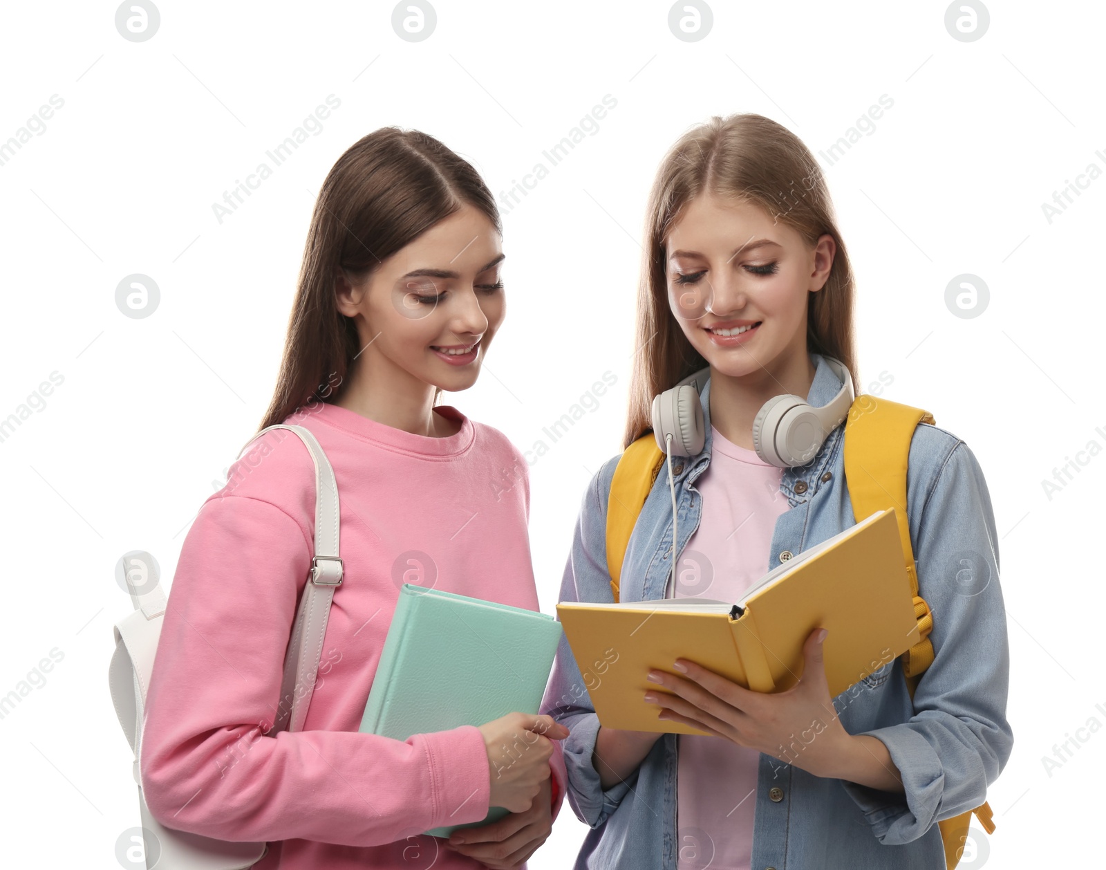 Photo of Teenage students with books and backpacks on white background