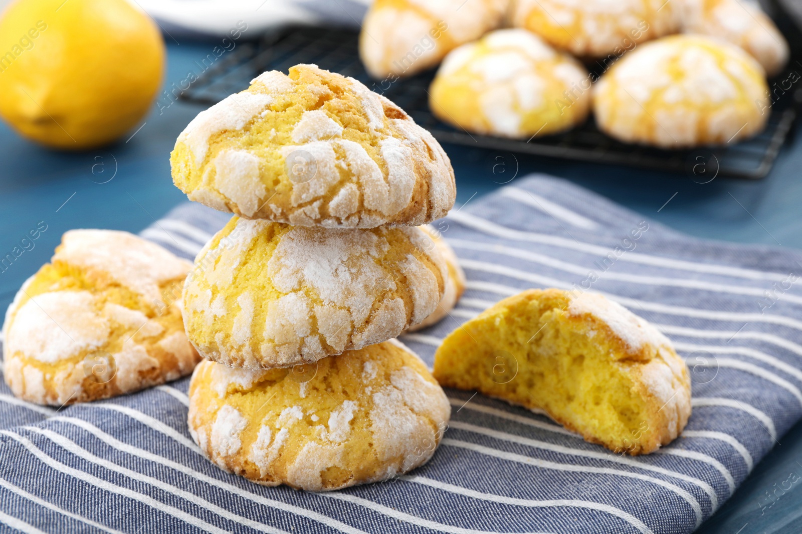 Photo of Tasty homemade lemon cookies on blue table, closeup