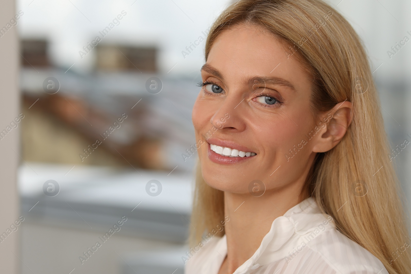 Photo of Portrait of confident entrepreneur or businesswoman, space for text. Beautiful lady with blonde hair smiling and looking into camera