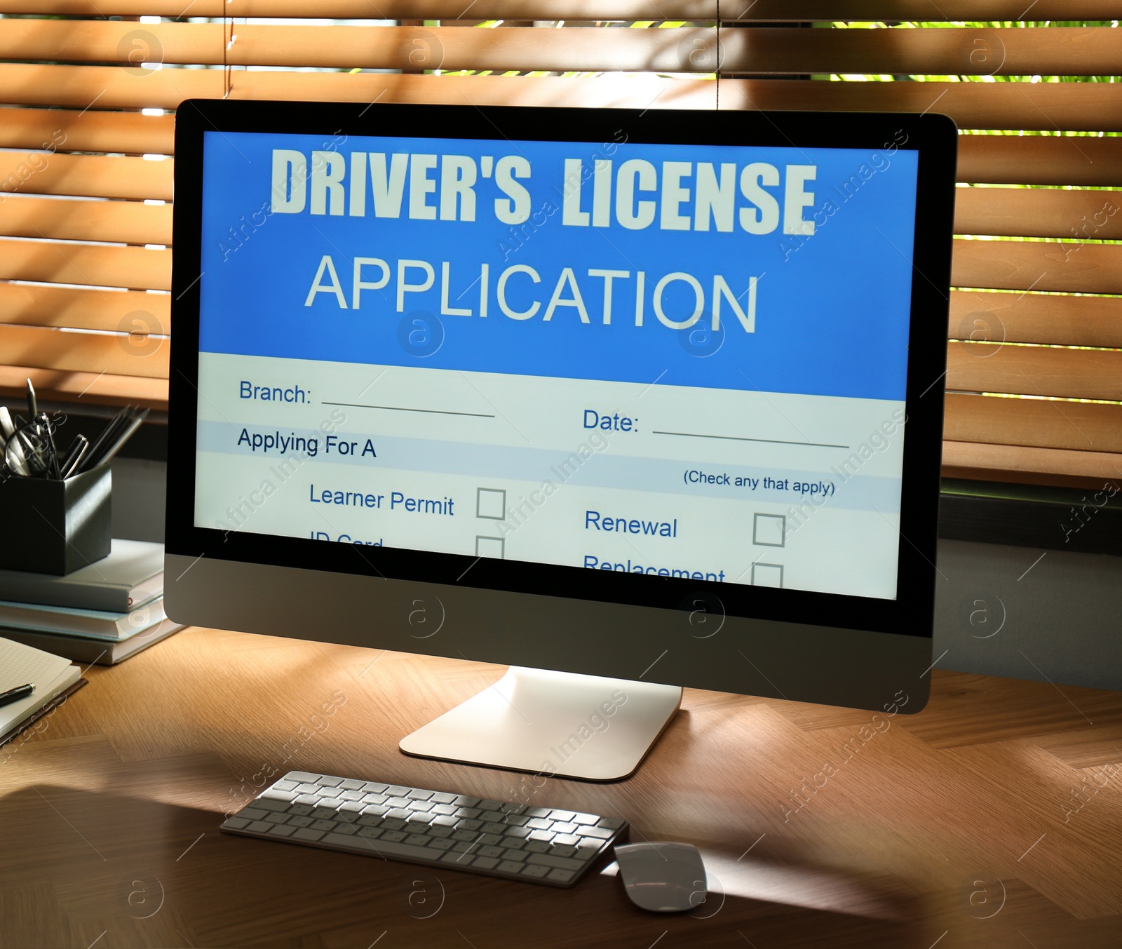 Photo of Computer with driver's license application form on table in office