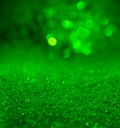 Image of St. Patrick day. Shiny green glitter, closeup. Bokeh effect