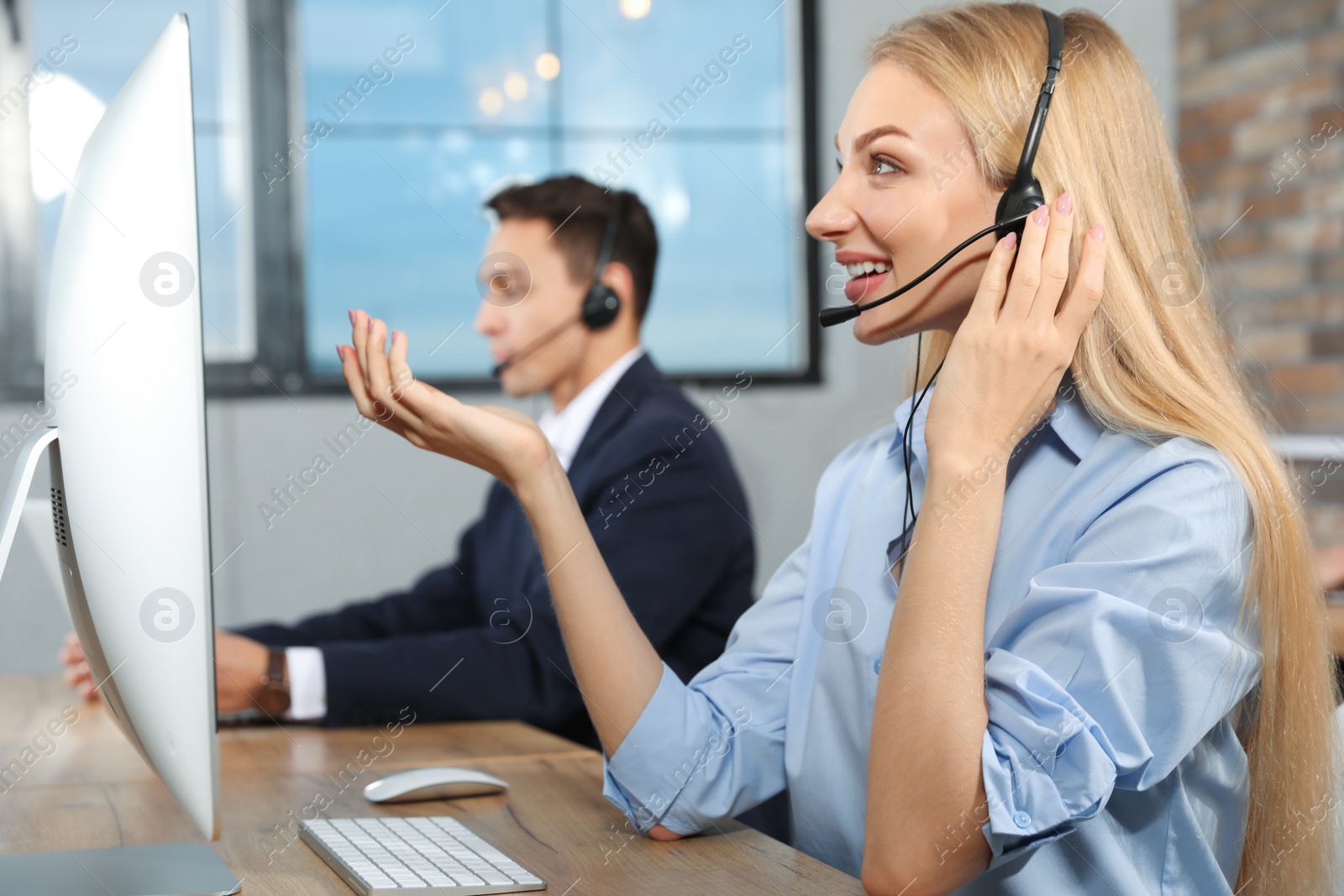 Photo of Technical support operator with colleague in modern office