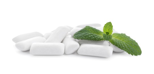 Photo of Heap of chewing gum pieces and mint on white background