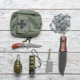 Set of military outfit on wooden background, flat lay