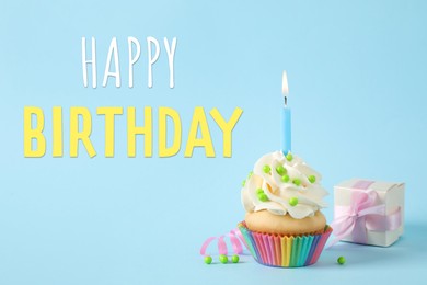 Image of Happy Birthday! Delicious cupcake with candle and gift box on light blue background