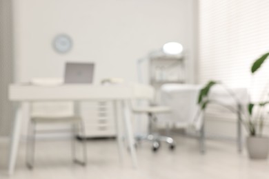 Blurred view of dermatologist's office with examination table