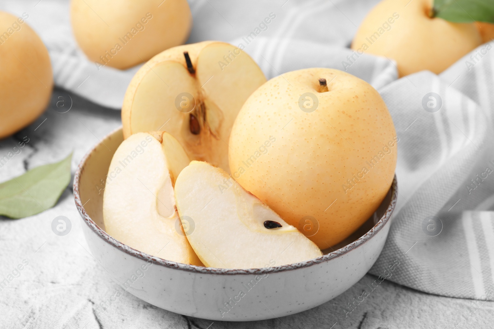 Photo of Delicious apple pears on white textured table