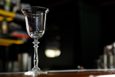 Photo of Empty clean glass on counter in bar. Space for text