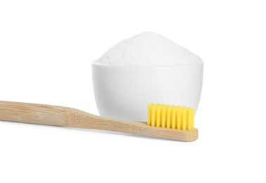 Photo of Bamboo toothbrush and bowl with baking soda on white background