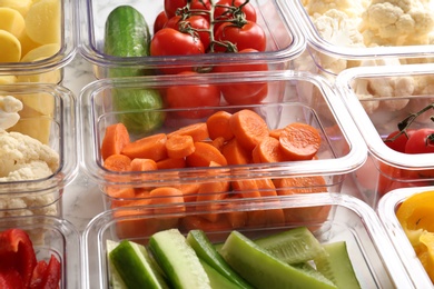 Photo of Many boxes with different raw vegetables, closeup