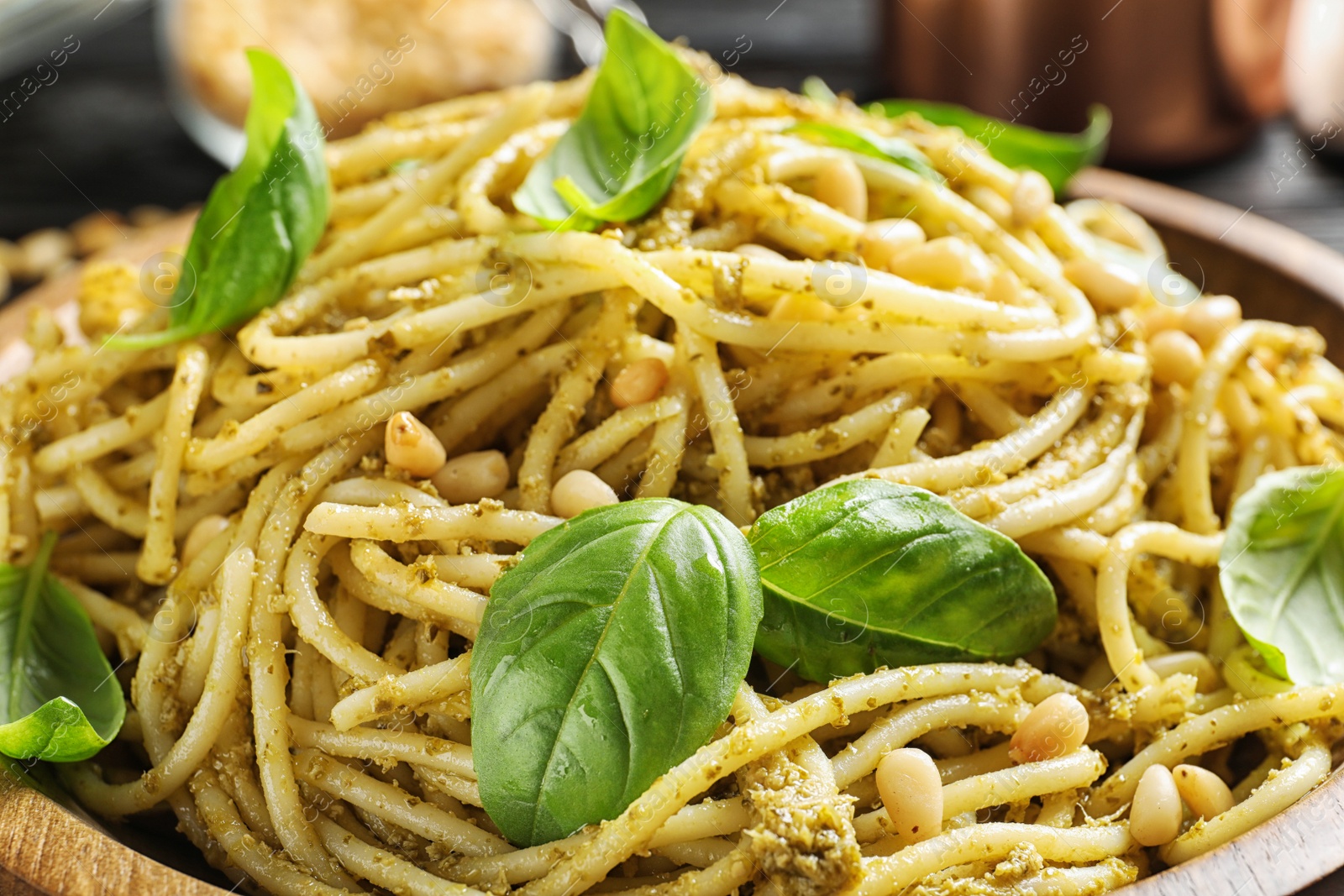 Photo of Delicious basil pesto pasta in plate, closeup