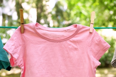 Photo of Laundry line with clothes outdoors on sunny day