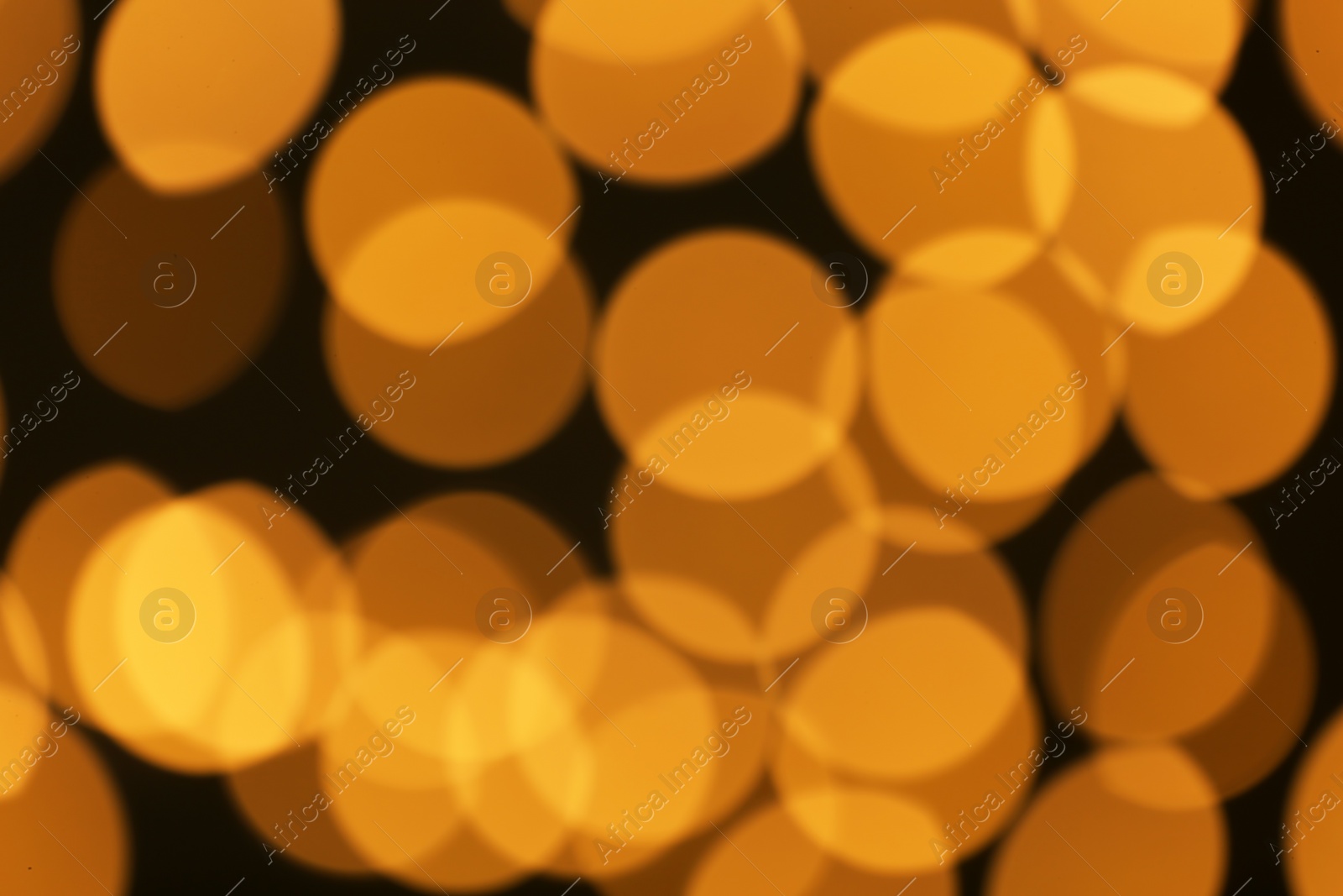 Photo of Beautiful golden lights on dark background. Bokeh effect