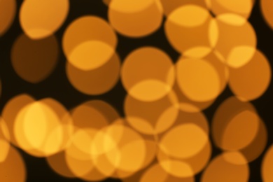 Photo of Beautiful golden lights on dark background. Bokeh effect