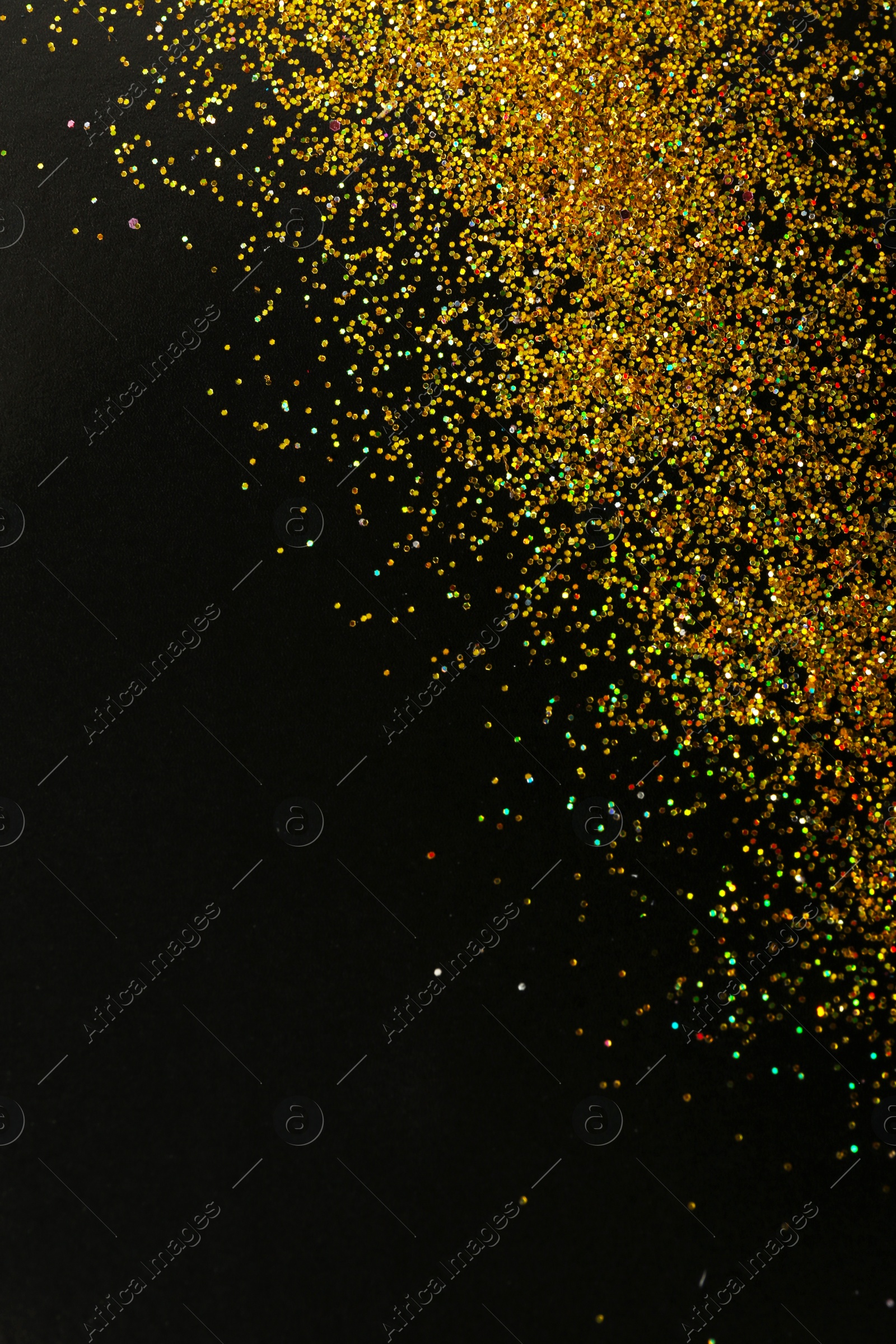 Photo of Gold glitter on black background, top view with space for text
