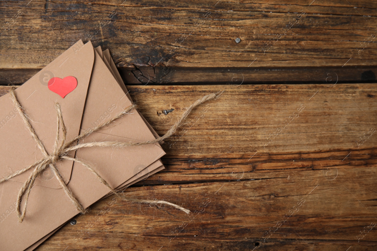 Photo of Stack of envelopes and space for text on wooden table, top view. Love letters