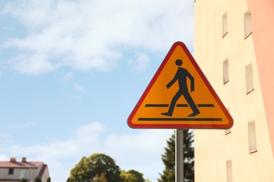 Photo of Traffic sign Pedestrian Crossing Ahead on city street, space for text