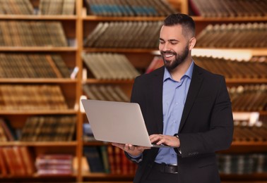 Image of Lawyer with laptop against shelves with books