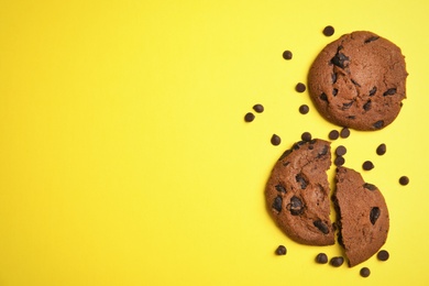 Photo of Delicious chocolate chip cookies on color background, flat lay. Space for text