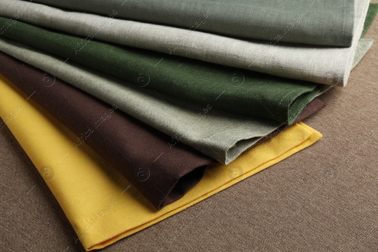 Photo of Many different color fabrics on brown cloth