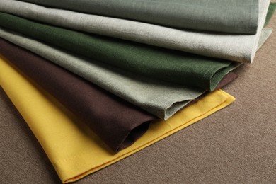 Photo of Many different color fabrics on brown cloth