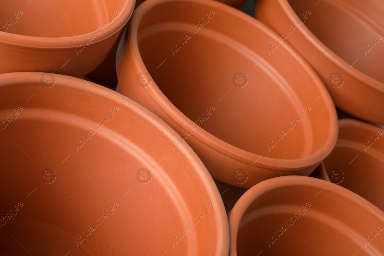 Photo of Many clay flower pots as background, closeup