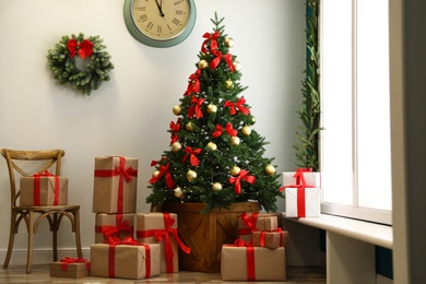 Photo of Decorated Christmas tree with gifts. Festive interior