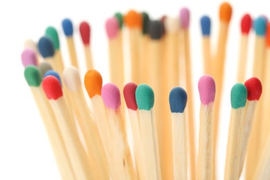 Matches with colorful heads on white background, closeup