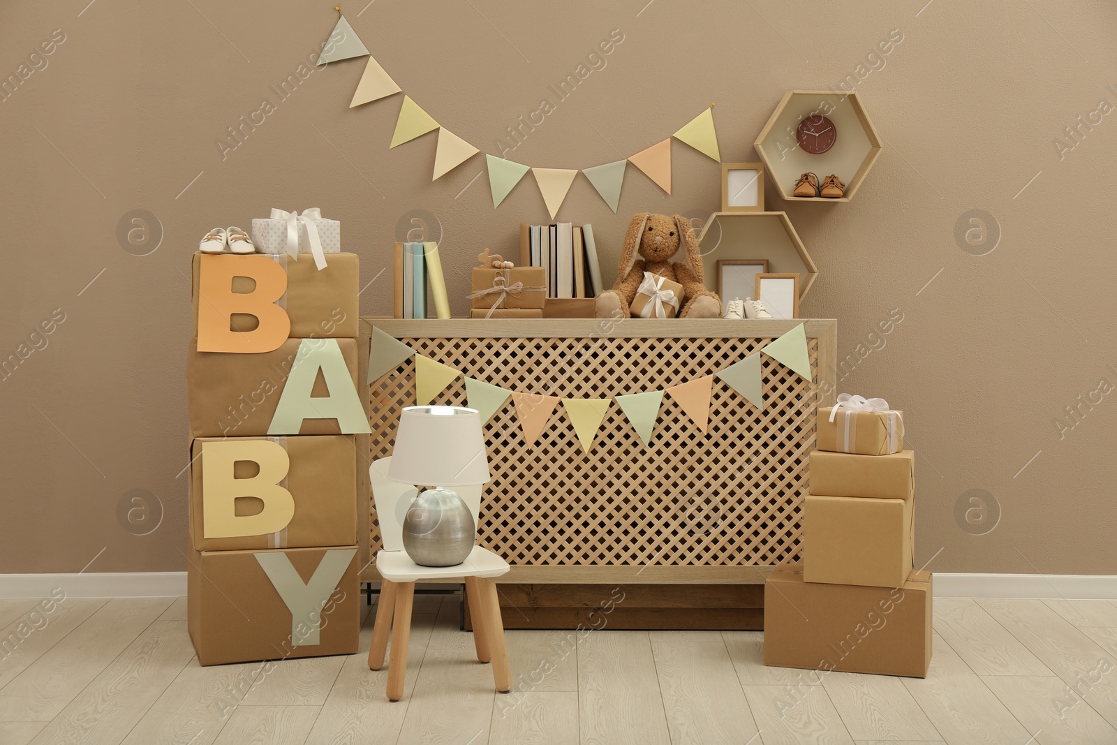 Photo of Gift boxes and toys in room decorated for baby shower party