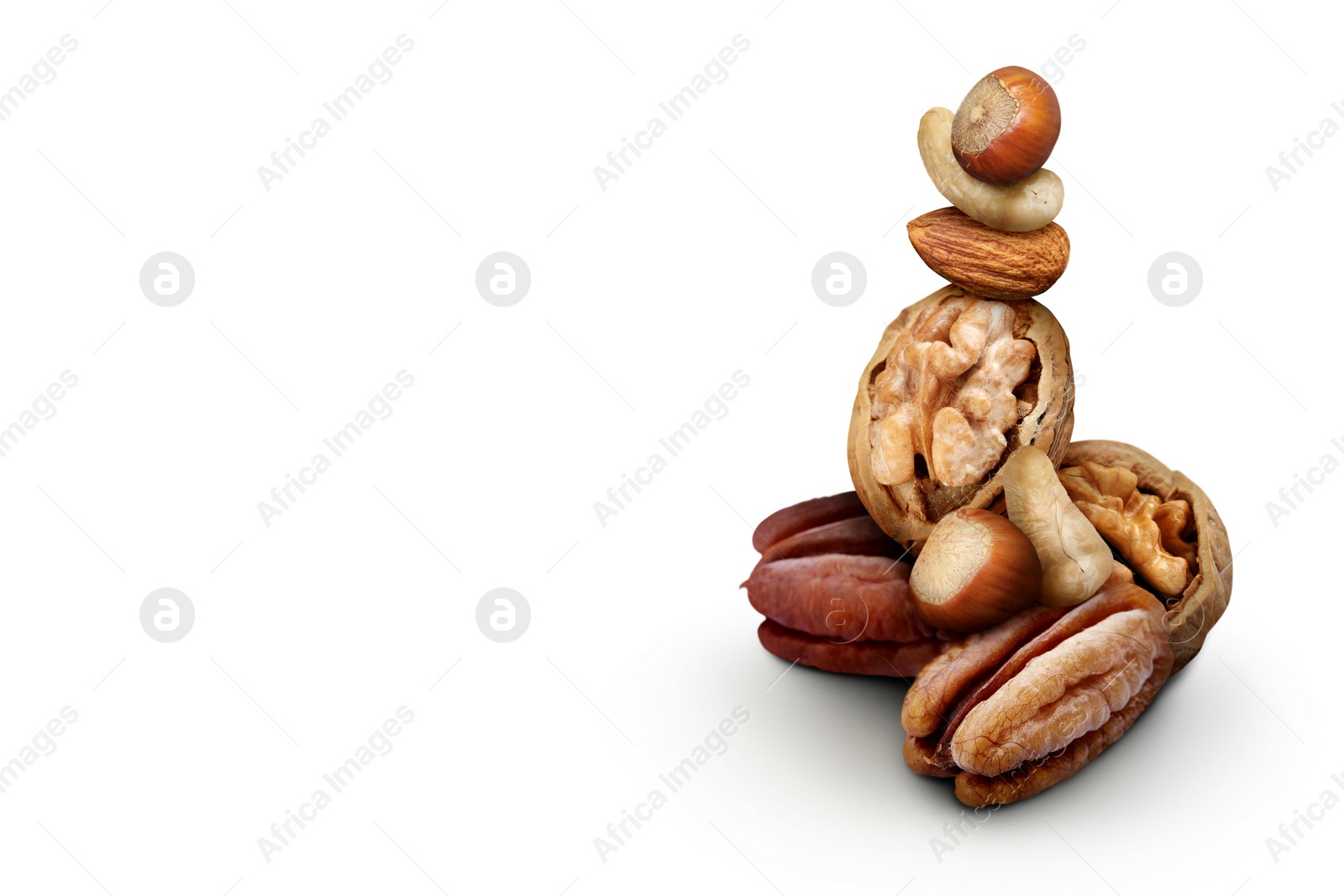 Image of Many different nuts on white background. Hazelnut, cashew, almond, walnut and pecan