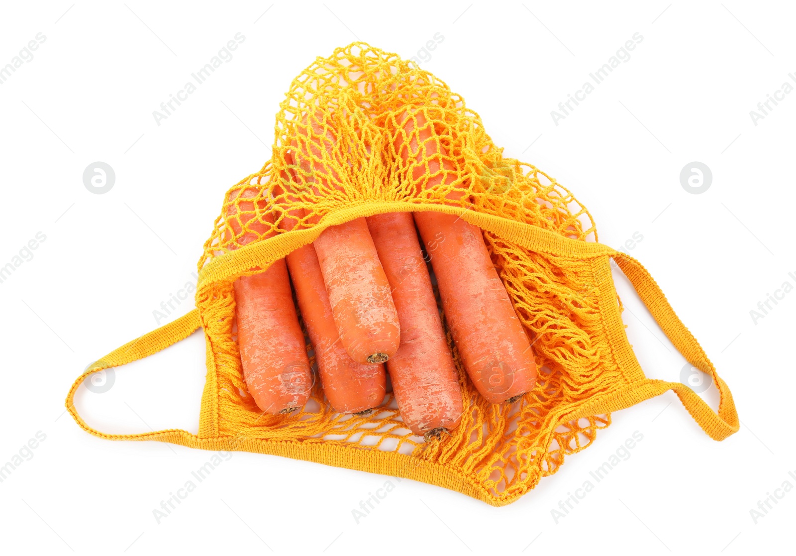 Photo of String bag with carrots isolated on white, top view