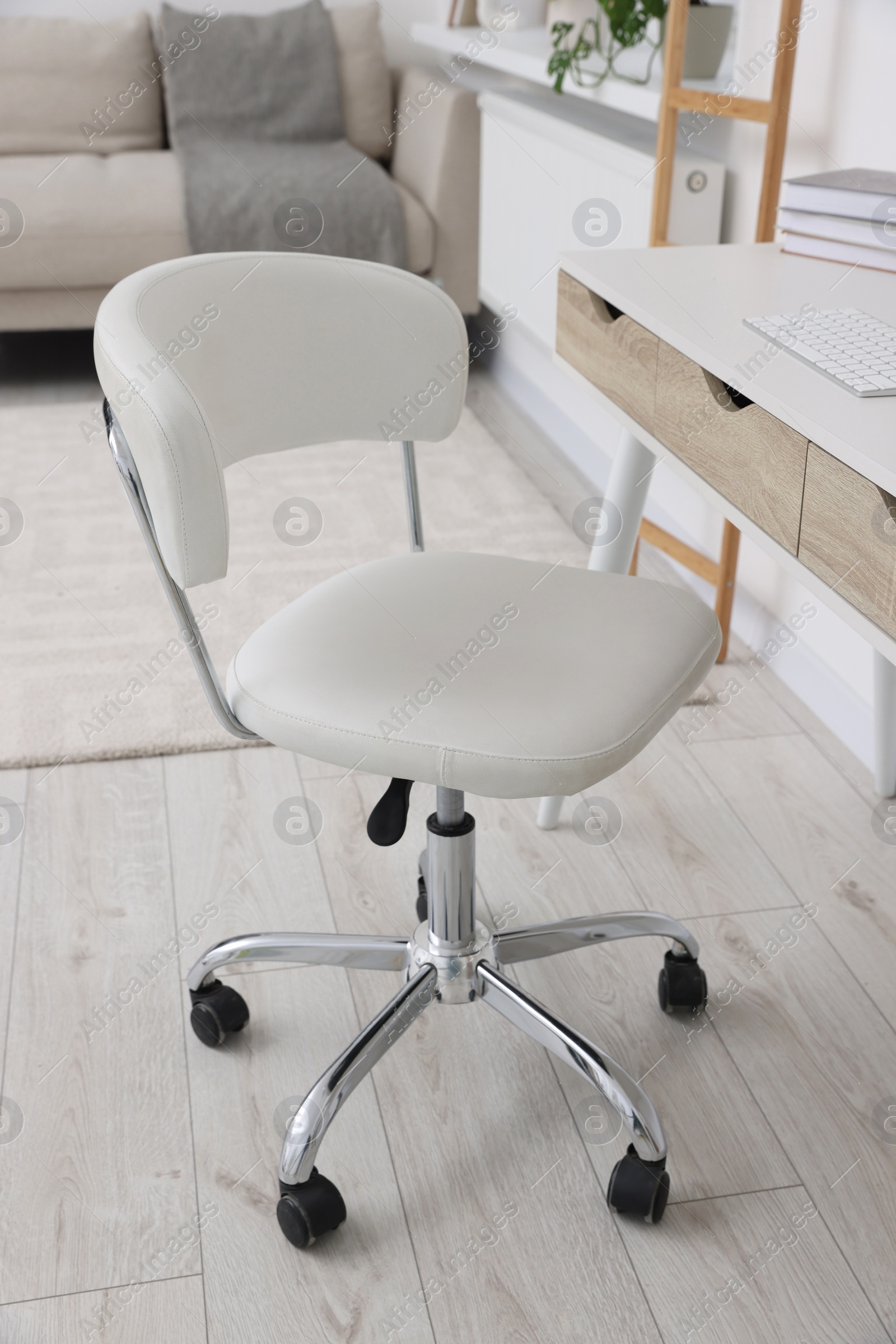 Photo of Workplace with comfortable office chair indoors. Interior design