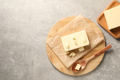 Photo of Tasty butter on grey table, top view. Space for text