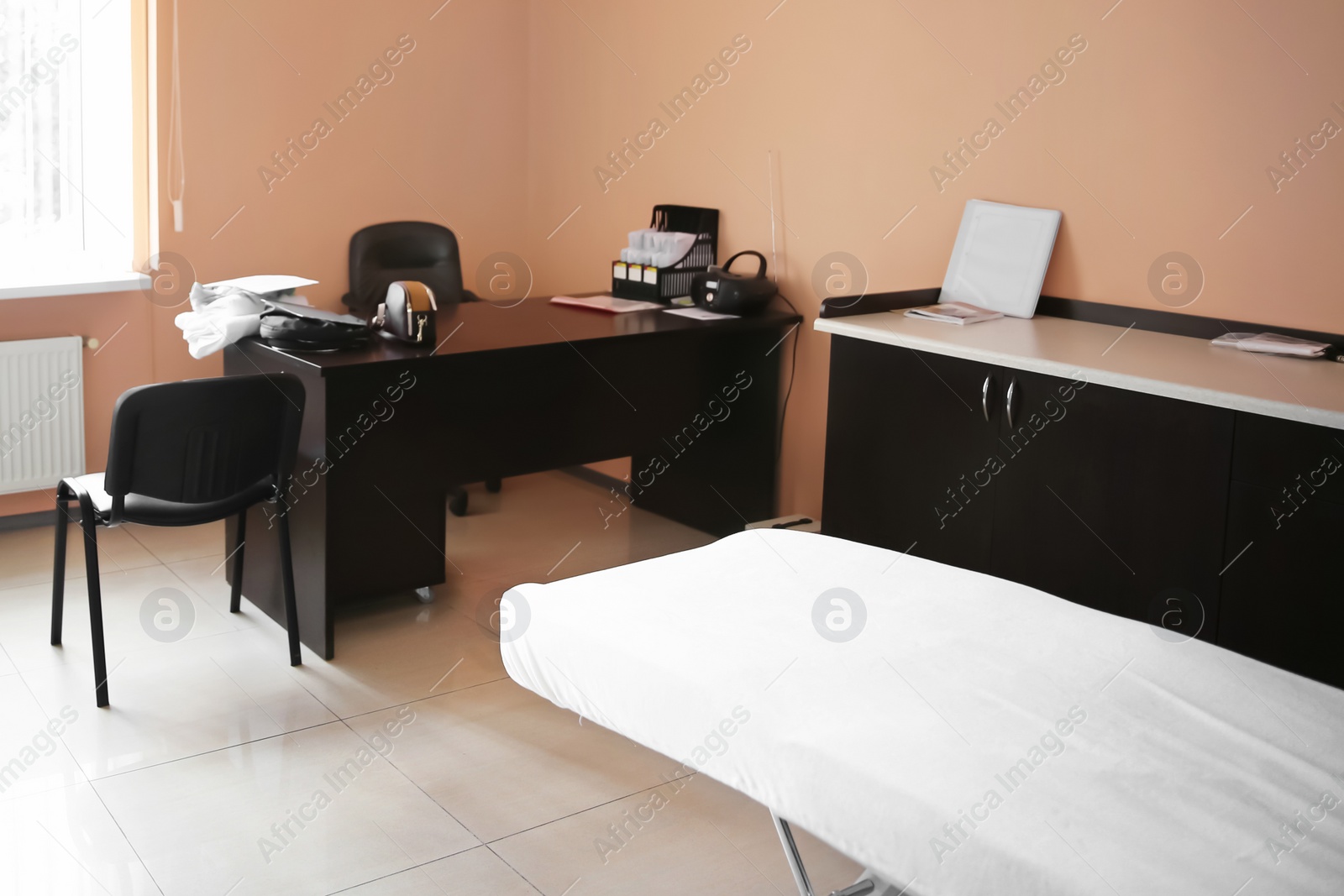 Photo of Office with massage table and desk. Professional epilation