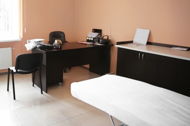 Photo of Office with massage table and desk. Professional epilation