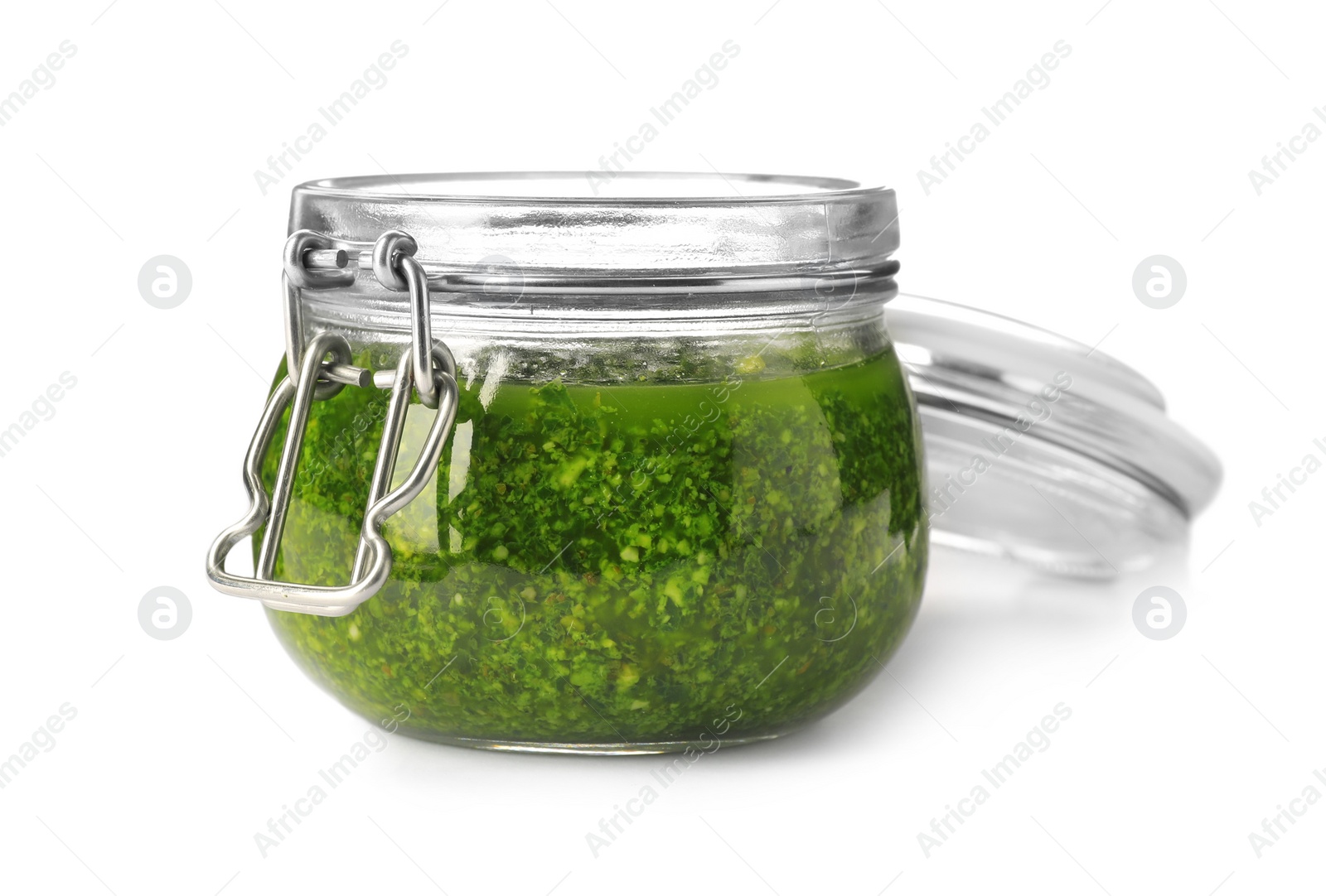 Photo of Homemade basil pesto sauce in glass jar on white background