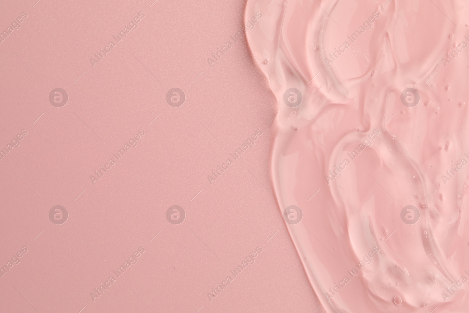 Photo of Clear cosmetic gel on pink background, top view. Space for text