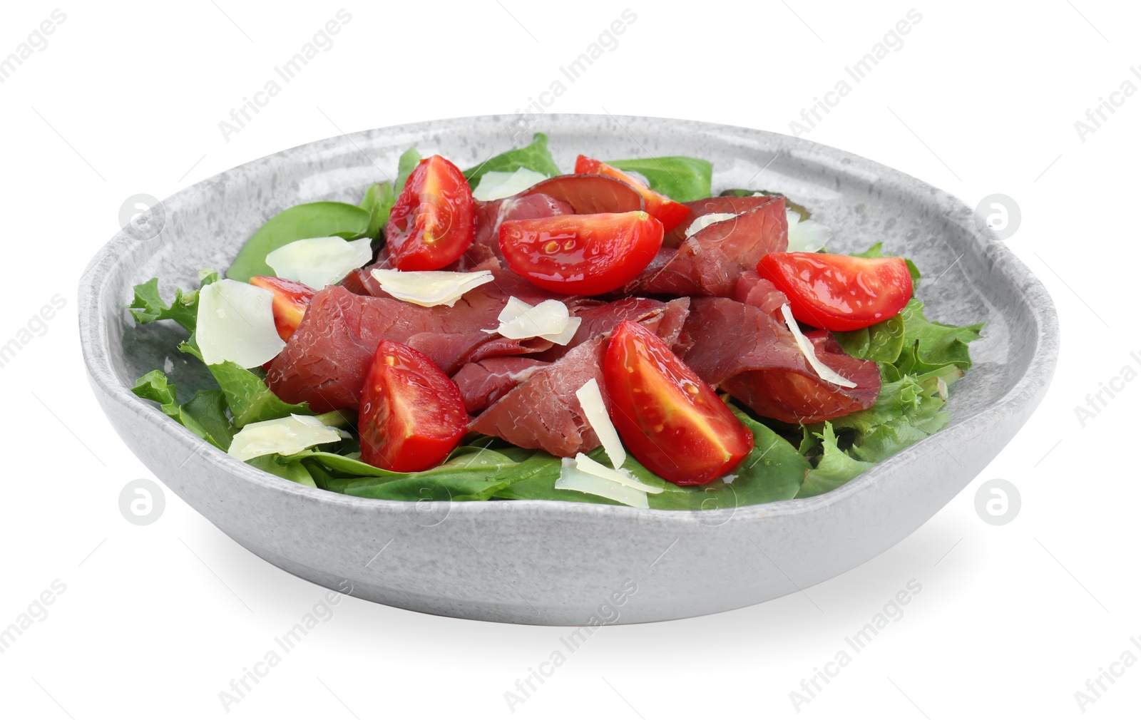 Photo of Delicious bresaola salad with tomatoes and parmesan cheese isolated on white