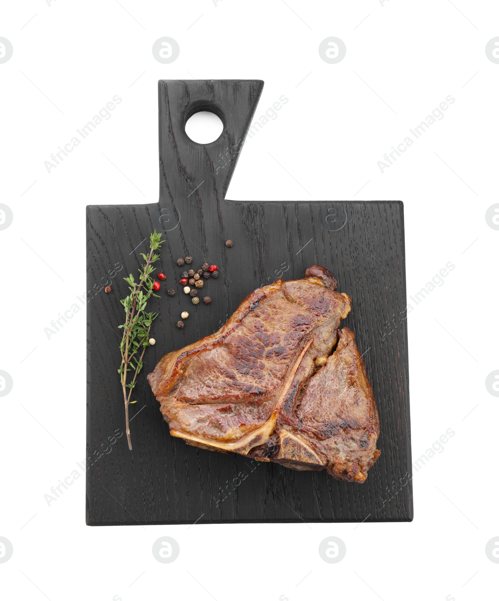 Photo of Delicious fried beef meat, thyme and peppercorns isolated on white, top view