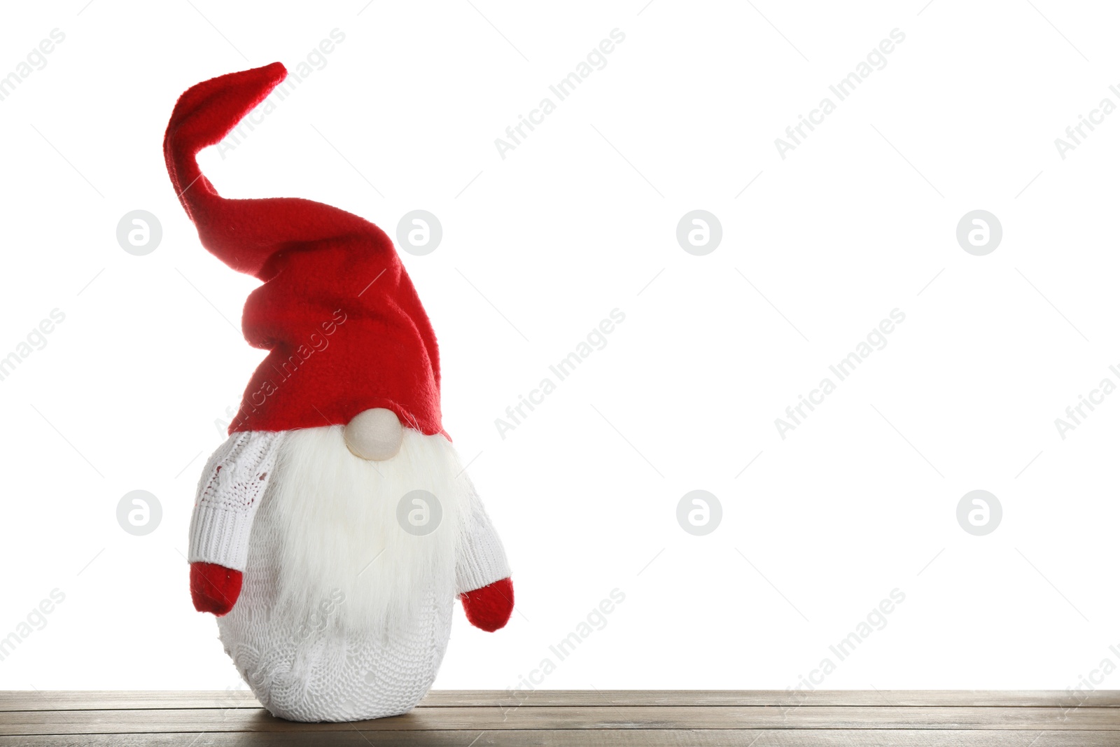 Photo of Funny Christmas gnome on wooden table against white background. Space for text