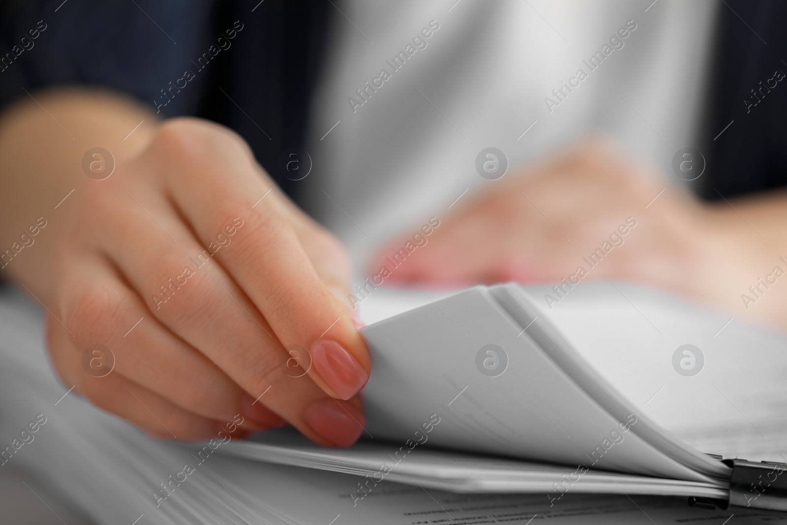 Photo of Woman reading documents at table in office, closeup. Space for text