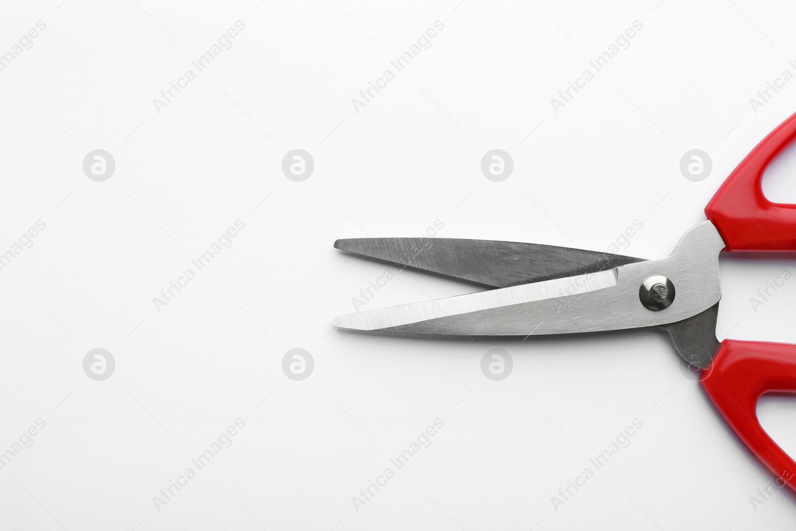 Photo of Pair of sharp scissors on white background