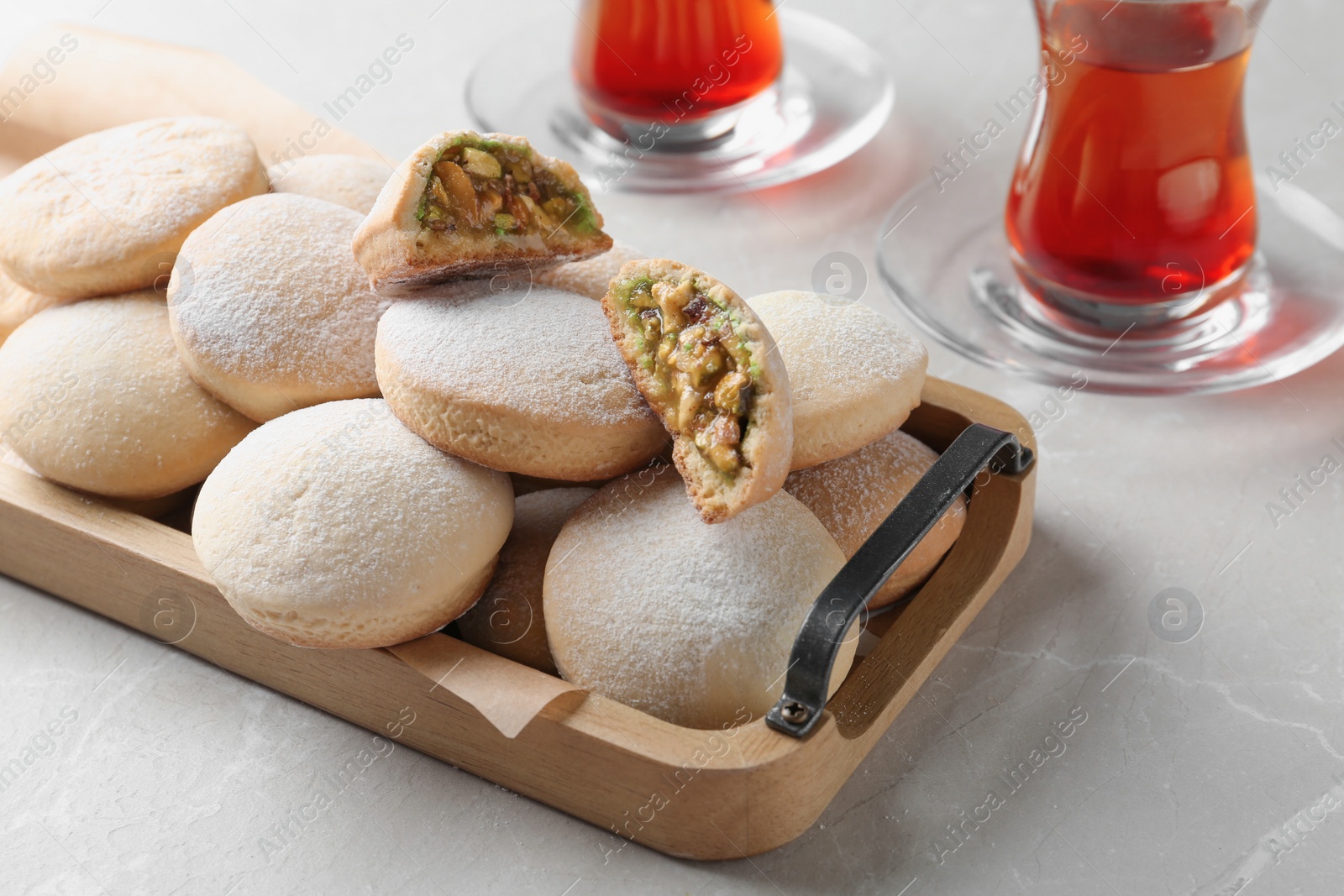 Photo of Traditional cookies for Islamic holidays and tea on table. Eid Mubarak