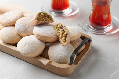 Photo of Traditional cookies for Islamic holidays and tea on table. Eid Mubarak