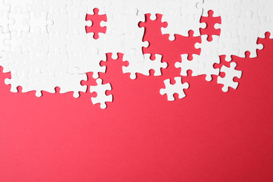 Photo of Blank white puzzle pieces on red background, flat lay. Space for text